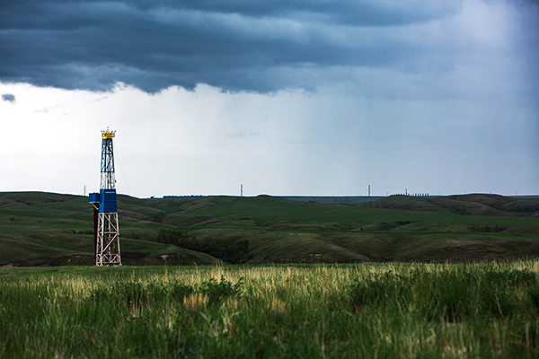 Photo of an oil rig during a rain storm.