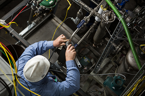 a man in a hard hat holding a wrench