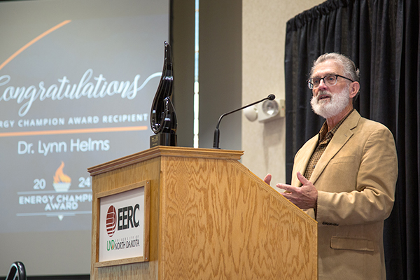 Man standing at a podium addressing an audience